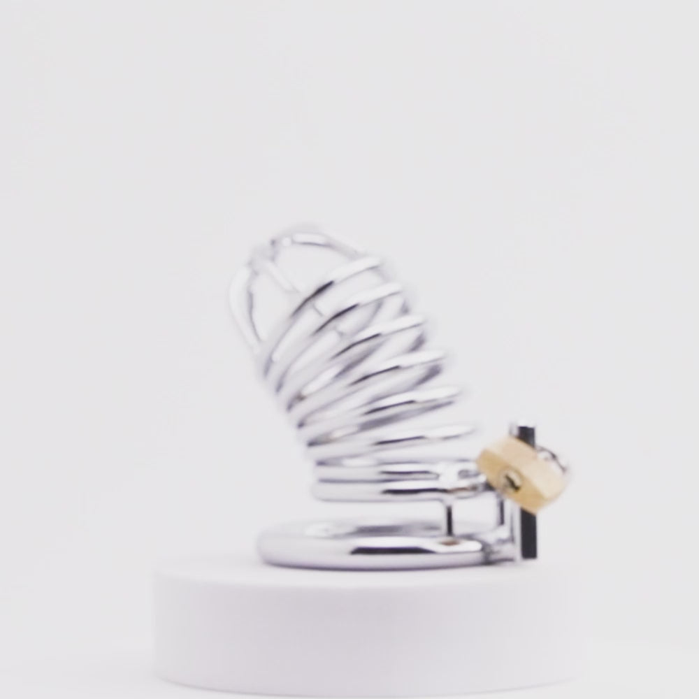 Embrace control and heightened sensations with this spiral-designed steel cage. Keeping his sensitive parts securely enclosed, the cool touch of metal leaves him aroused yet restrained. Wearable even while peeing, it won't hurt but ensures he stays obedient.