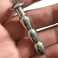 Elevate your urethral play with our ribbed metal plug, tailored for size versatility from smaller to intense widths. Combat shrink fears and embrace controlled expansion all while erect!